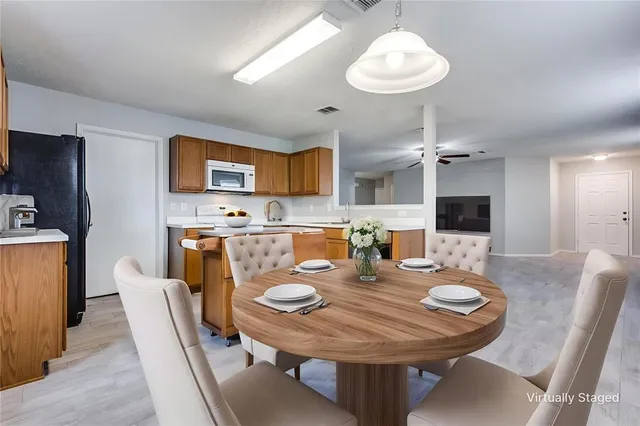 a dining room with furniture a window and a chandelier