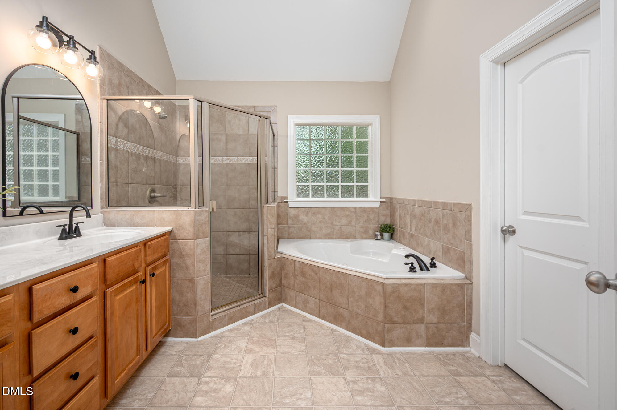 726 Ruth Circle Fuquay-Varina, NC 27526 - Photo 28 of 61 a bathroom with a tub sink and mirror
