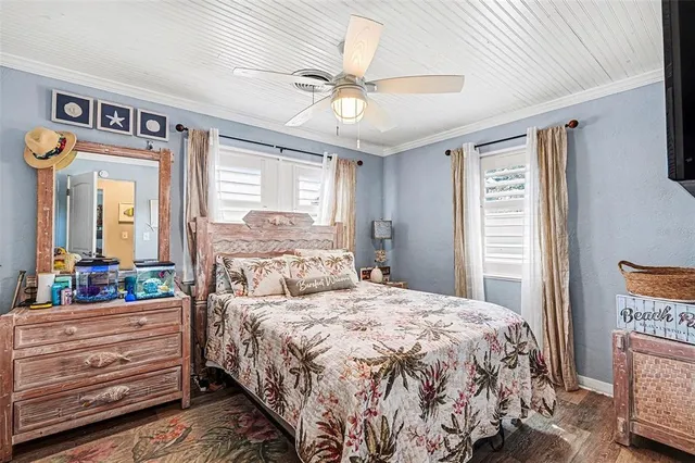 a bedroom with a bed a dresser and a window