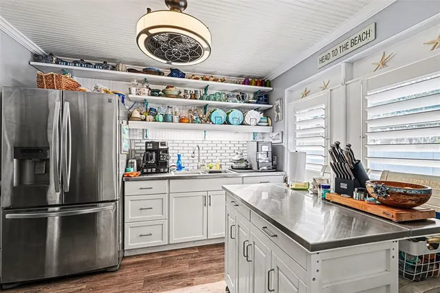 a kitchen with a refrigerator a sink and cabinets