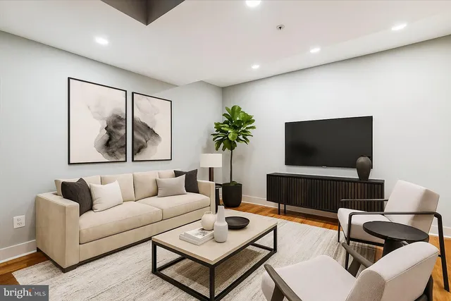 a living room with furniture and a flat screen tv