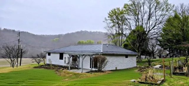 a view of a house with a yard balcony and sitting area