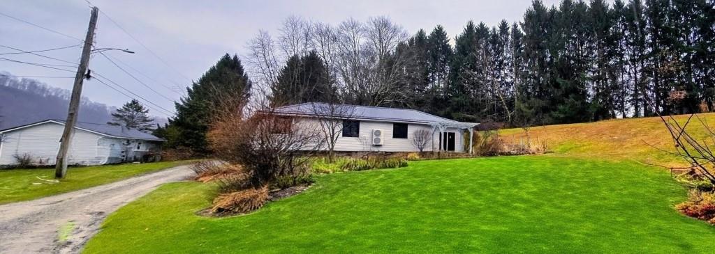 916 Indiana Avenue Avonmore, PA 15618 - Photo 32 of 32 a view of a house with a big yard plants and large trees