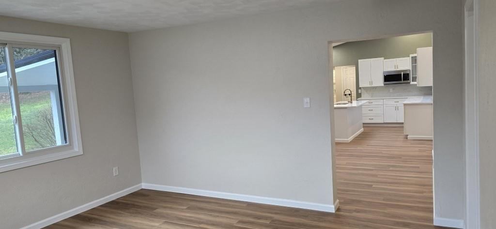 916 Indiana Avenue Avonmore, PA 15618 - Photo 8 of 32 a view of a hallway with wooden floor and a bathroom