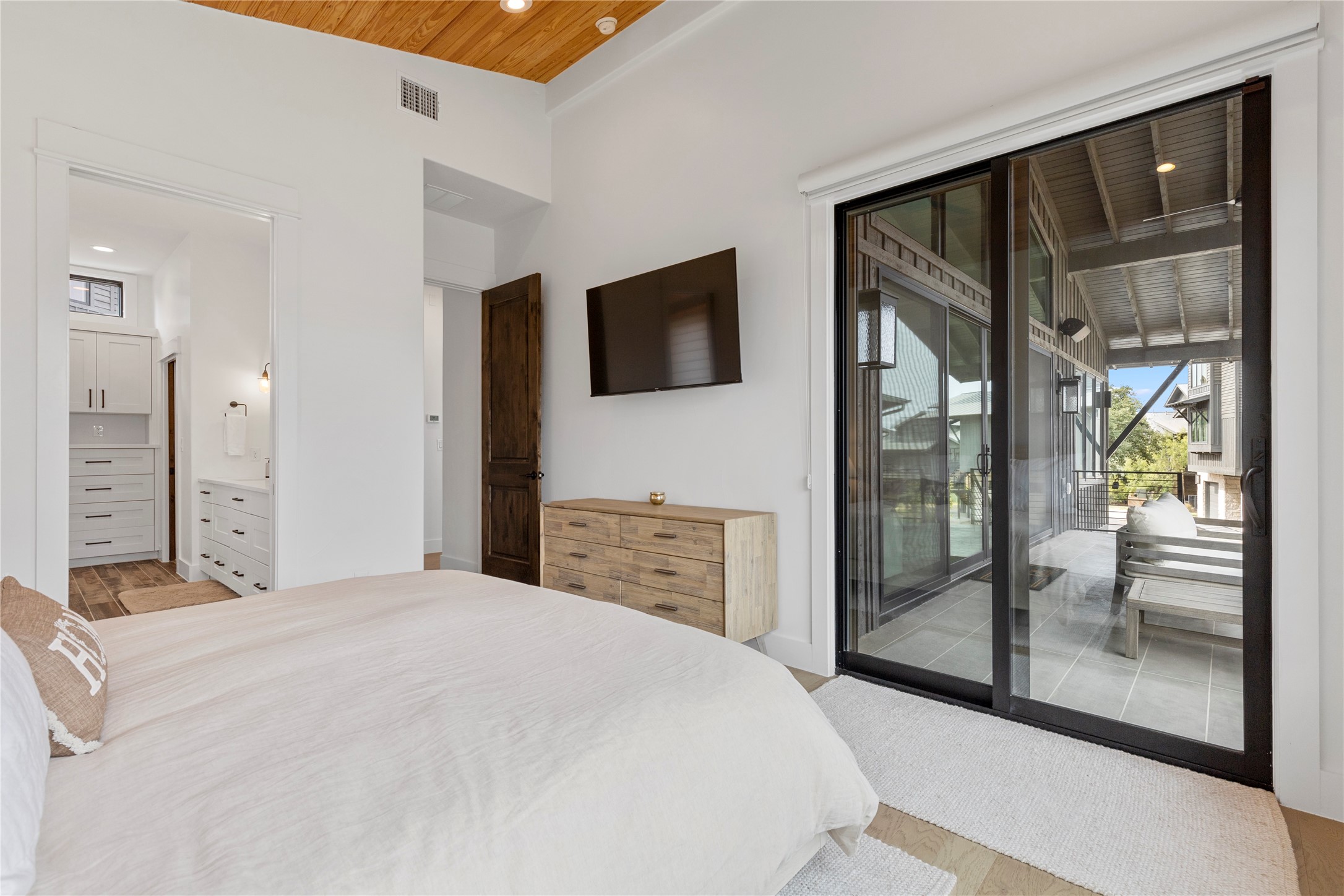 19216 Lost Tree, Unit 8 Spicewood, TX 78669 - Photo 11 of 27 Primary bedroom has sliding door onto the large balcony