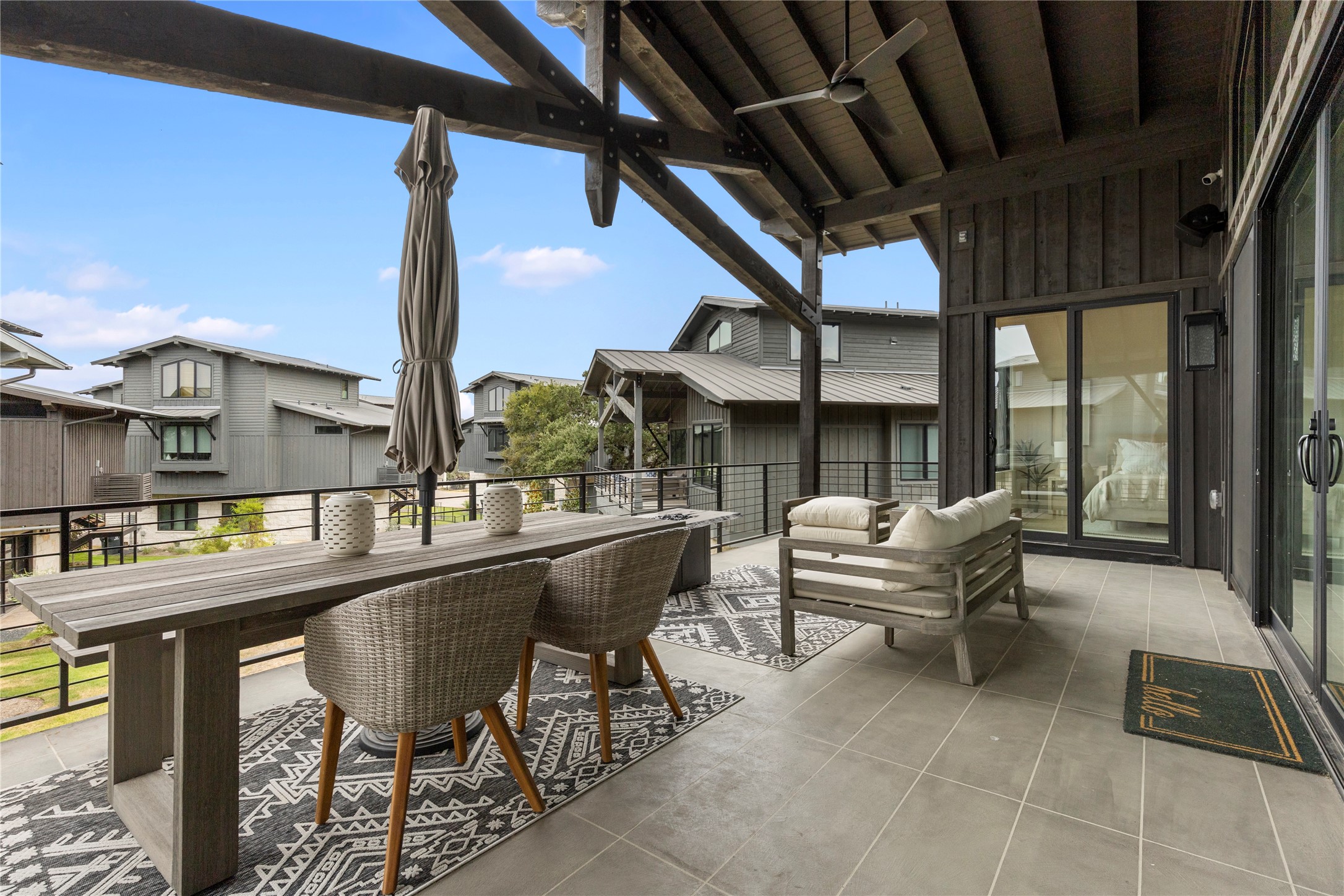 19216 Lost Tree, Unit 8 Spicewood, TX 78669 - Photo 24 of 27 Large balcony with gas firepit and ample room for dining under the stars