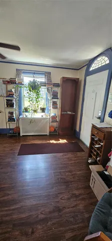 a view of a room with wooden floor and furniture