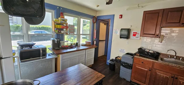 a kitchen with stainless steel appliances granite countertop a stove a sink dishwasher and a microwave oven with cabinets