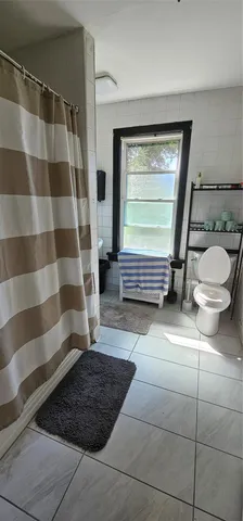 a bathroom with a toilet a sink and a shower