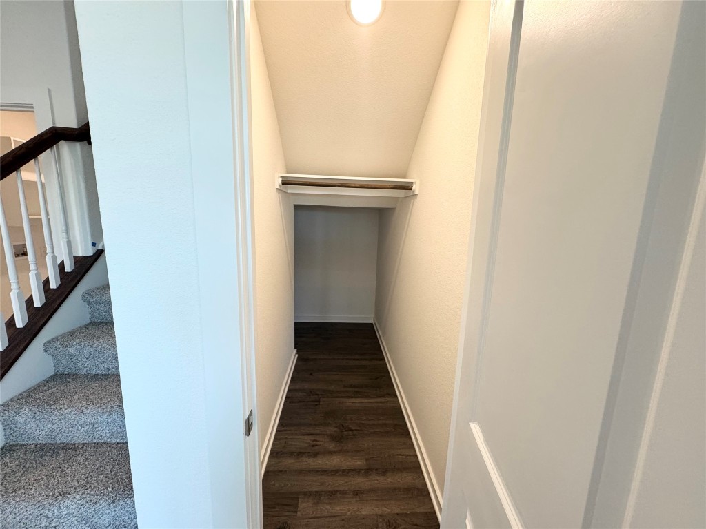 128 Hazy Vw Road San Marcos, TX 78666 - Photo 11 of 22 a view of a hallway with wooden floor and staircase