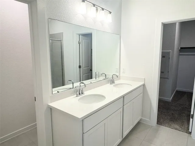 a bathroom that has a glass shower door