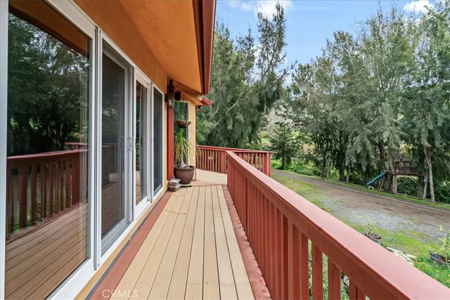 a living room with furniture a fireplace and a floor to ceiling window