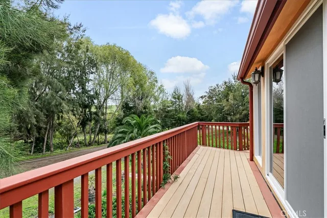 a living room with furniture a fireplace and a floor to ceiling window