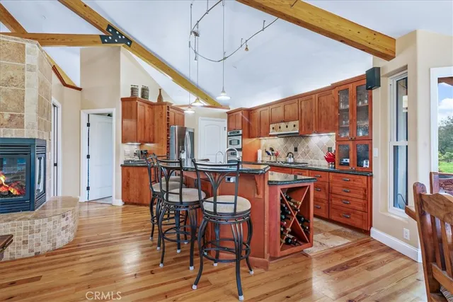 a kitchen with granite countertop stainless steel appliances a sink and cabinets