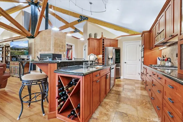 a kitchen with granite countertop a sink and cabinets