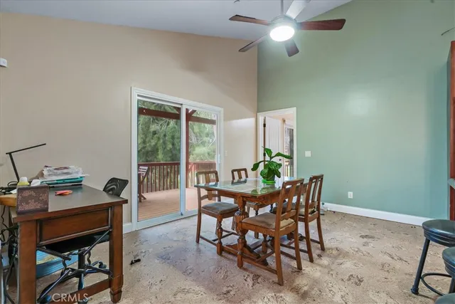 a view of a two chairs in the deck next to a yard