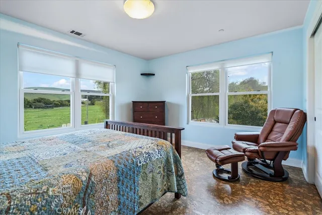 a living room with furniture and a baby crib