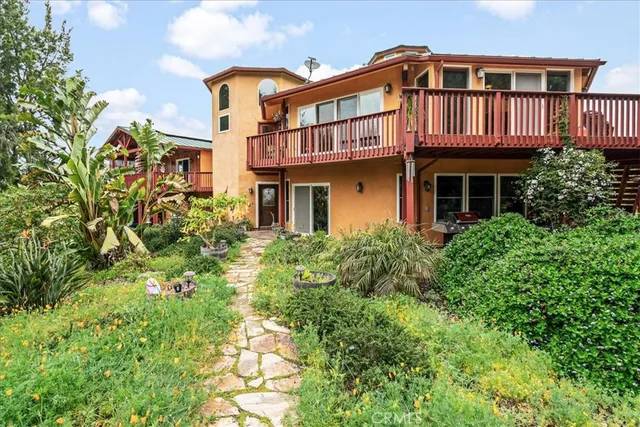 a view of a house with a yard and sitting area