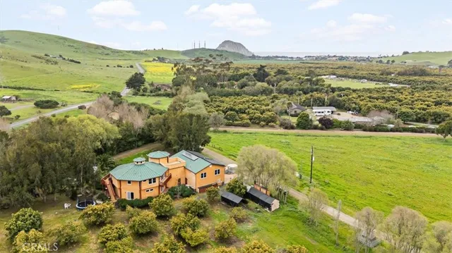 a living room with lots of furniture and a kitchen view