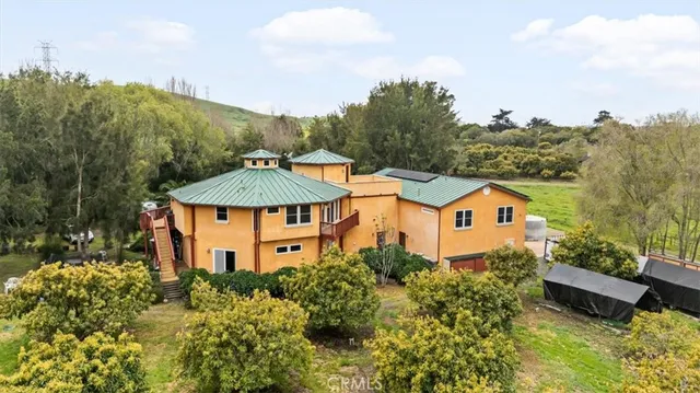 a living room with furniture a wooden floor and next to a window