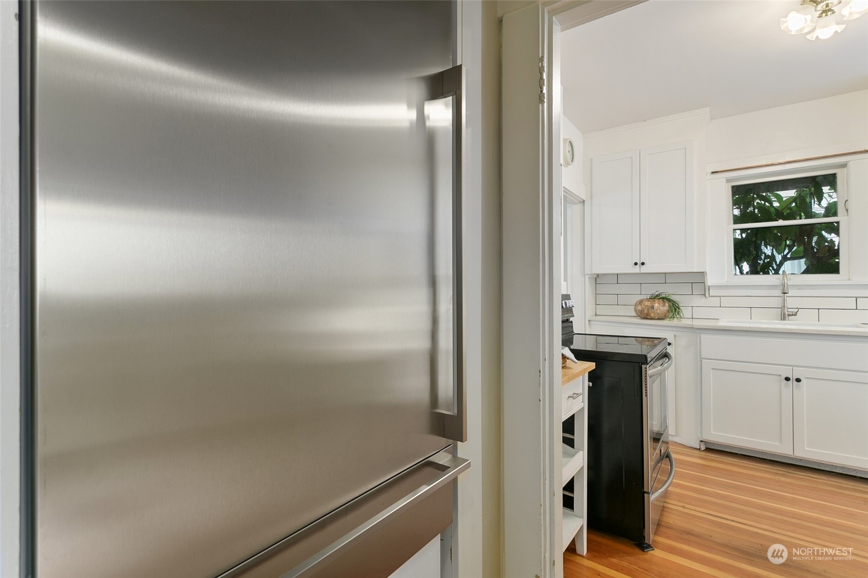 5942 41st Avenue Southwest Seattle, WA 98136 - Photo 12 of 40 a kitchen with refrigerator and window