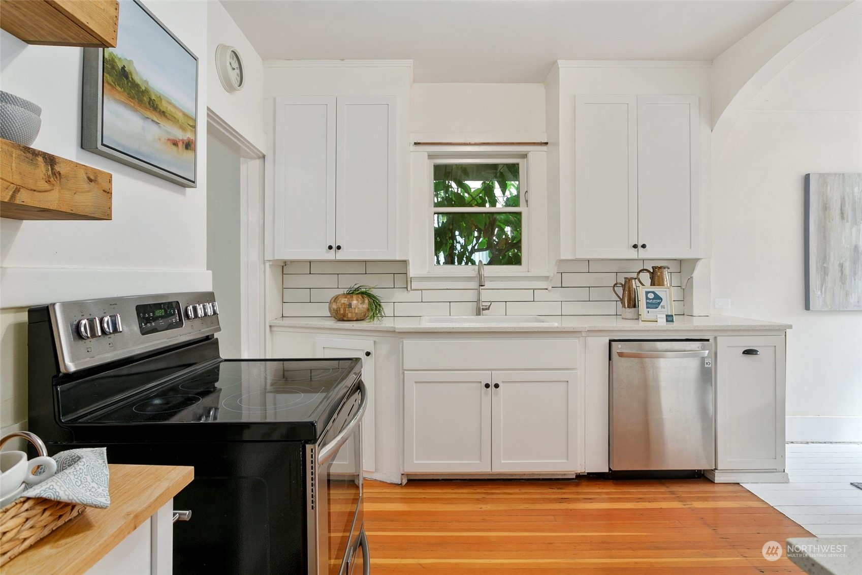 5942 41st Avenue Southwest Seattle, WA 98136 - Photo 14 of 40 a kitchen with stainless steel appliances a sink stove and cabinets