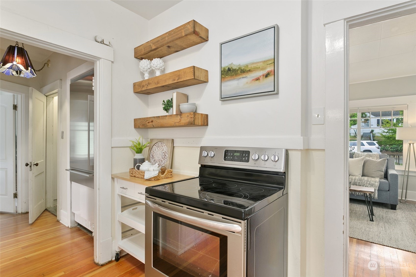 5942 41st Avenue Southwest Seattle, WA 98136 - Photo 15 of 40 a kitchen with stainless steel appliances and wooden floor