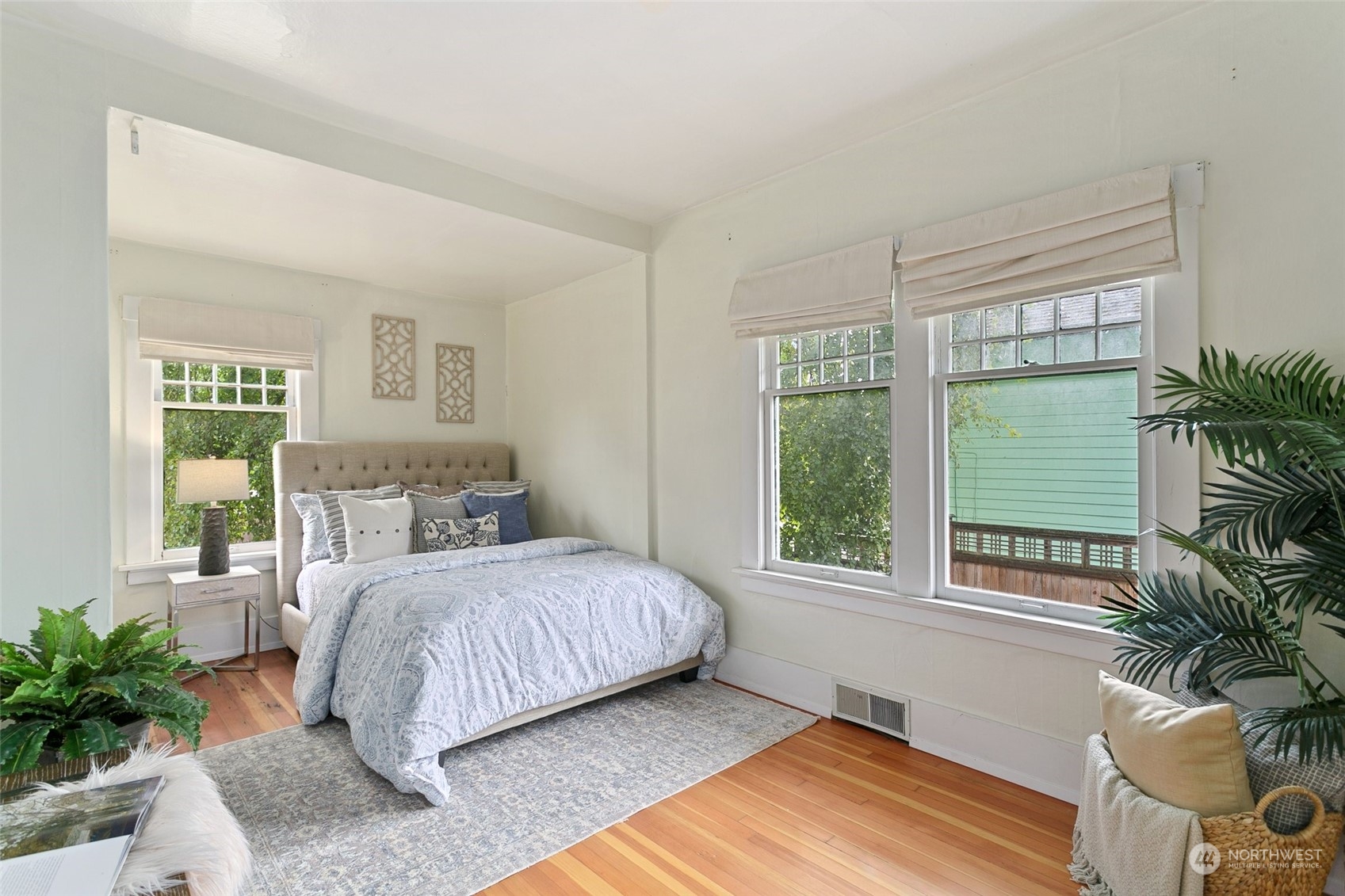 5942 41st Avenue Southwest Seattle, WA 98136 - Photo 20 of 40 a bedroom with a large bed and a potted plant