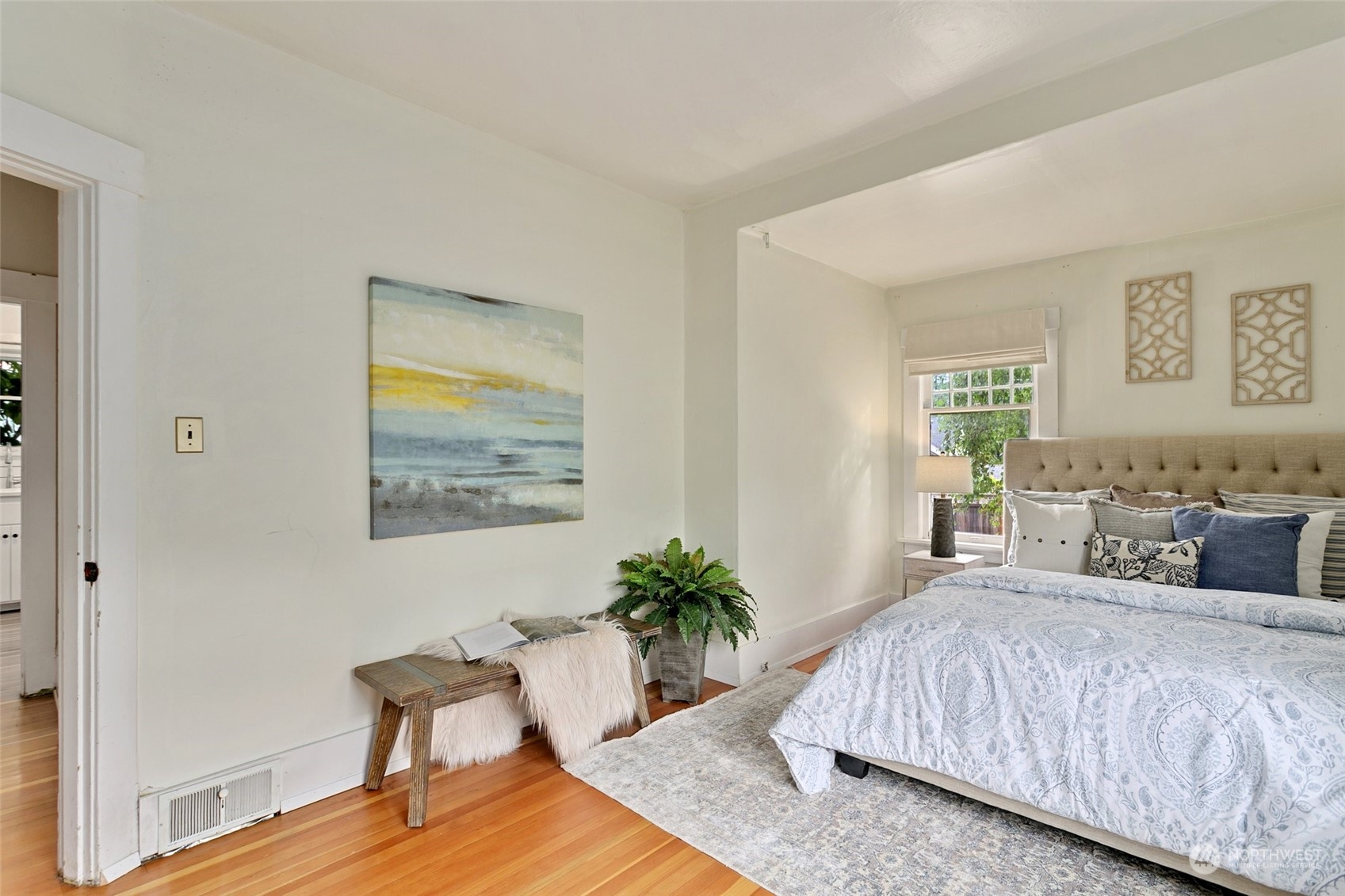 5942 41st Avenue Southwest Seattle, WA 98136 - Photo 21 of 40 a bedroom with a bed and a potted plant on dresser