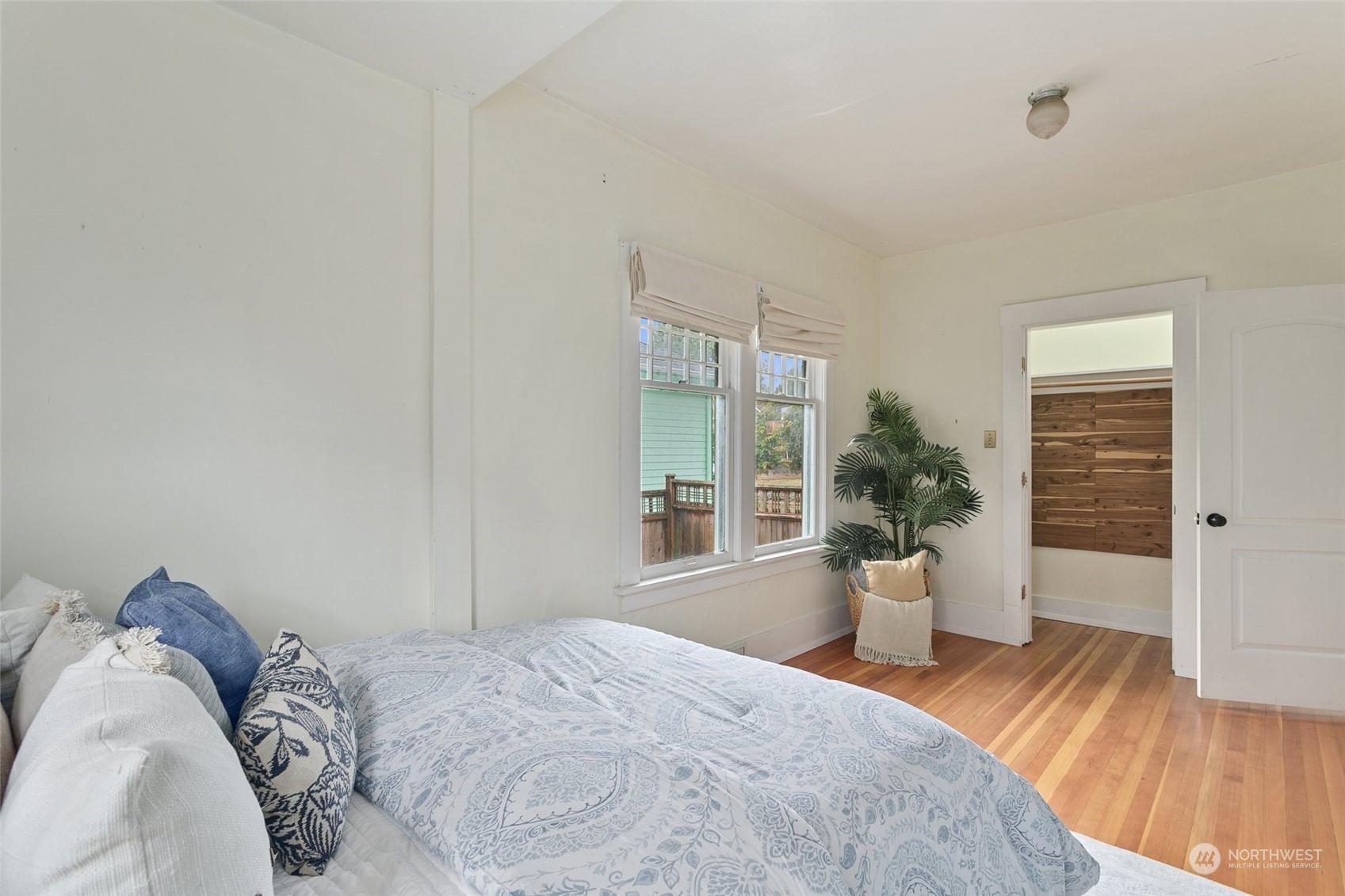 5942 41st Avenue Southwest Seattle, WA 98136 - Photo 22 of 40 a view of a bedroom with a bed and wooden floor