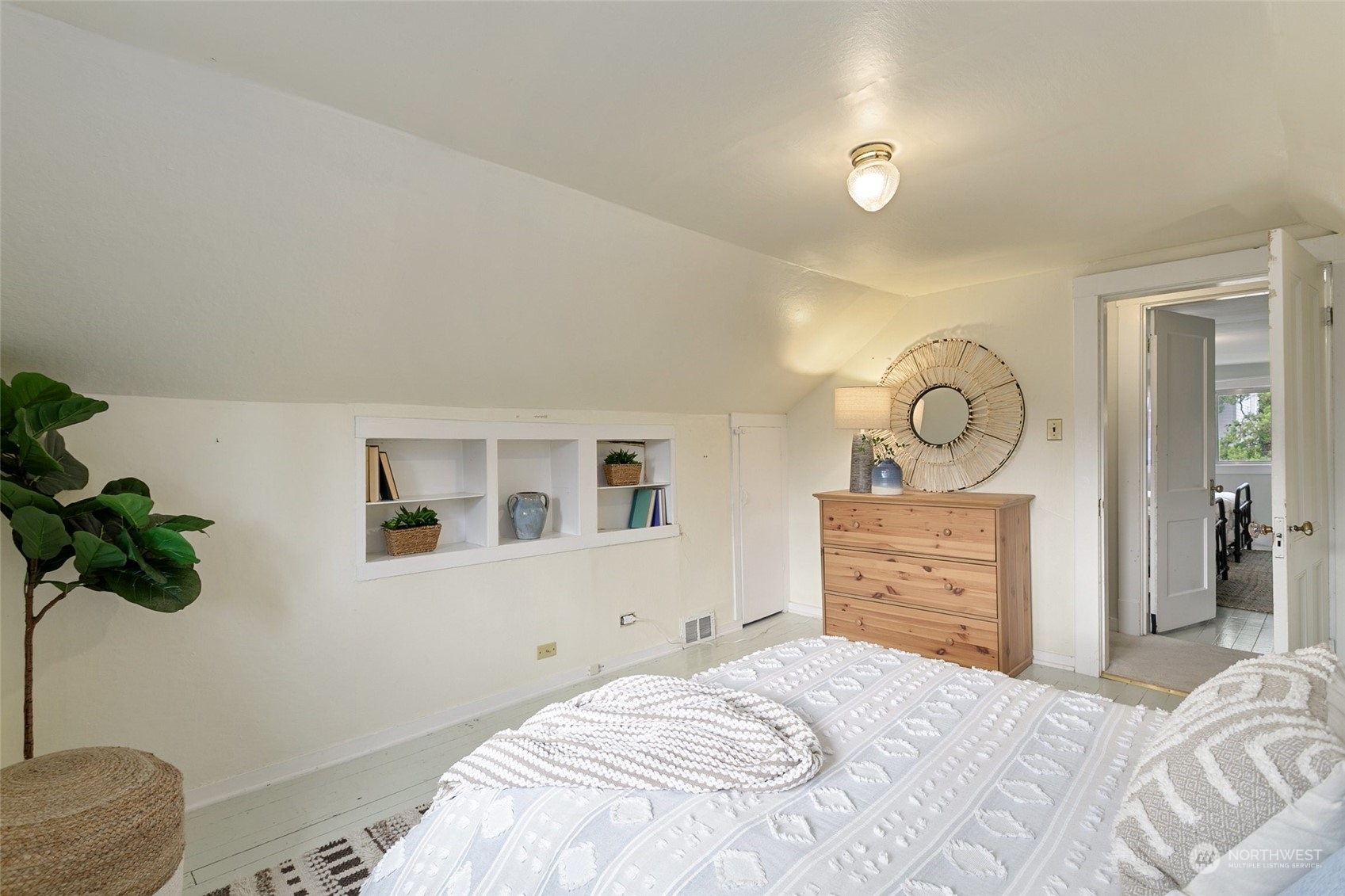5942 41st Avenue Southwest Seattle, WA 98136 - Photo 26 of 40 a bedroom with a bed and a potted plant