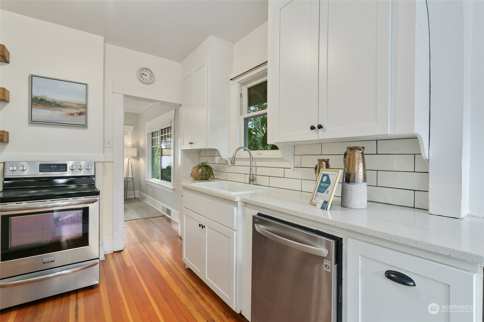 5942 41st Avenue Southwest Seattle, WA 98136 - Photo 10 of 40 a kitchen with stainless steel appliances granite countertop a stove a sink and white cabinets