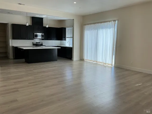 a view of kitchen with cabinets and wooden floor