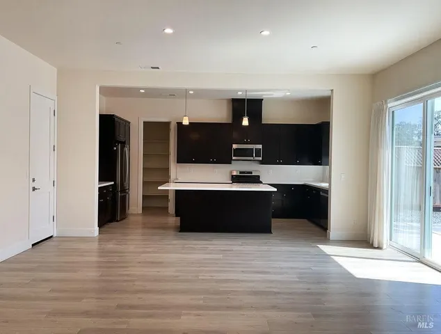 a large kitchen with a table and chairs