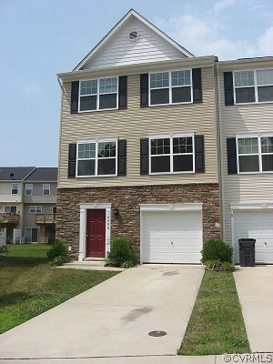 18296 Democracy Avenue Ruther Glen, VA 22546 - Photo 1 of 7 a front view of a house with a yard and garage