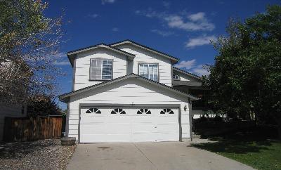 6383 Laguna Circle Highlands Ranch, CO 80130 - Photo 1 of 1 a front view of a house with a yard and garage