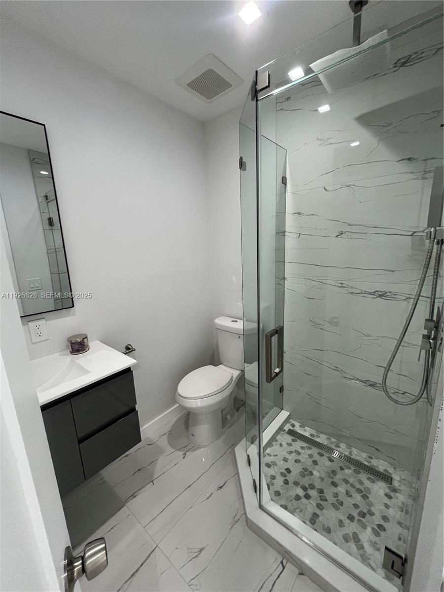 1653 Southwest 17th Terrace, Unit FRONT Miami, FL 33145 - Photo 11 of 25 a bathroom with a toilet sink and shower