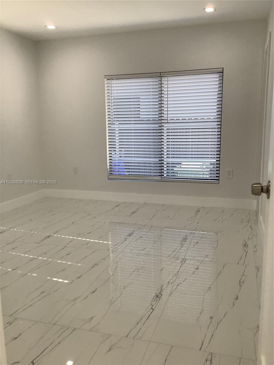1653 Southwest 17th Terrace, Unit FRONT Miami, FL 33145 - Photo 9 of 25 a view of an empty room with a window