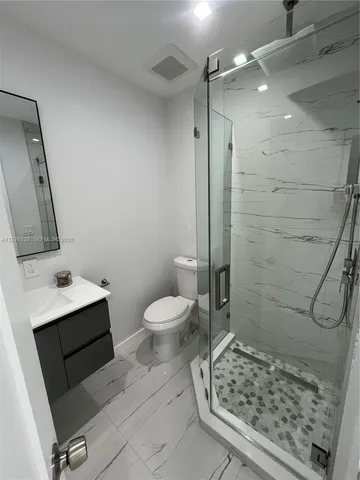 a bathroom with a toilet sink and shower