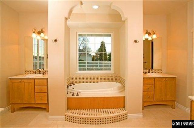 300 Vera Drive Reno, NV 89511 - Photo 9 of 13 a bathroom with a tub sink and mirror