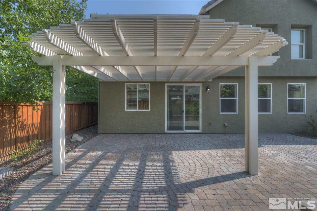 11105 Parma Way Reno, NV 89521 - Photo 23 of 32 a view of backyard with large windows and a table and chairs