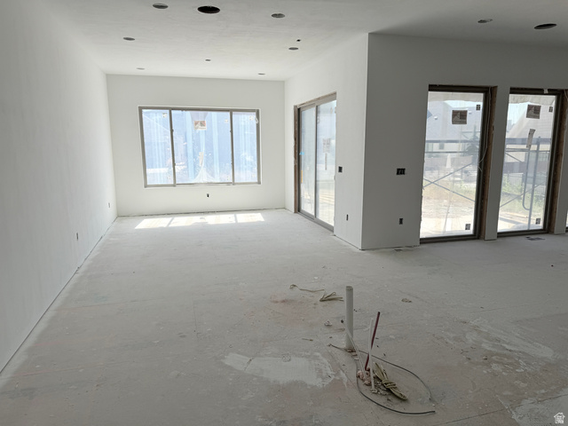 208 East 400 South Mapleton, UT 84664 - Photo 16 of 20 Recessed lighting, large windows, sliding glass doors, white walls, and unfinished concrete flooring