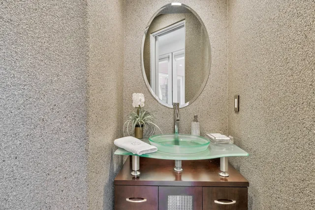 wooden floor with a mirror and a sink