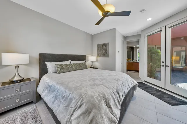 a bedroom with a bed and a lamp