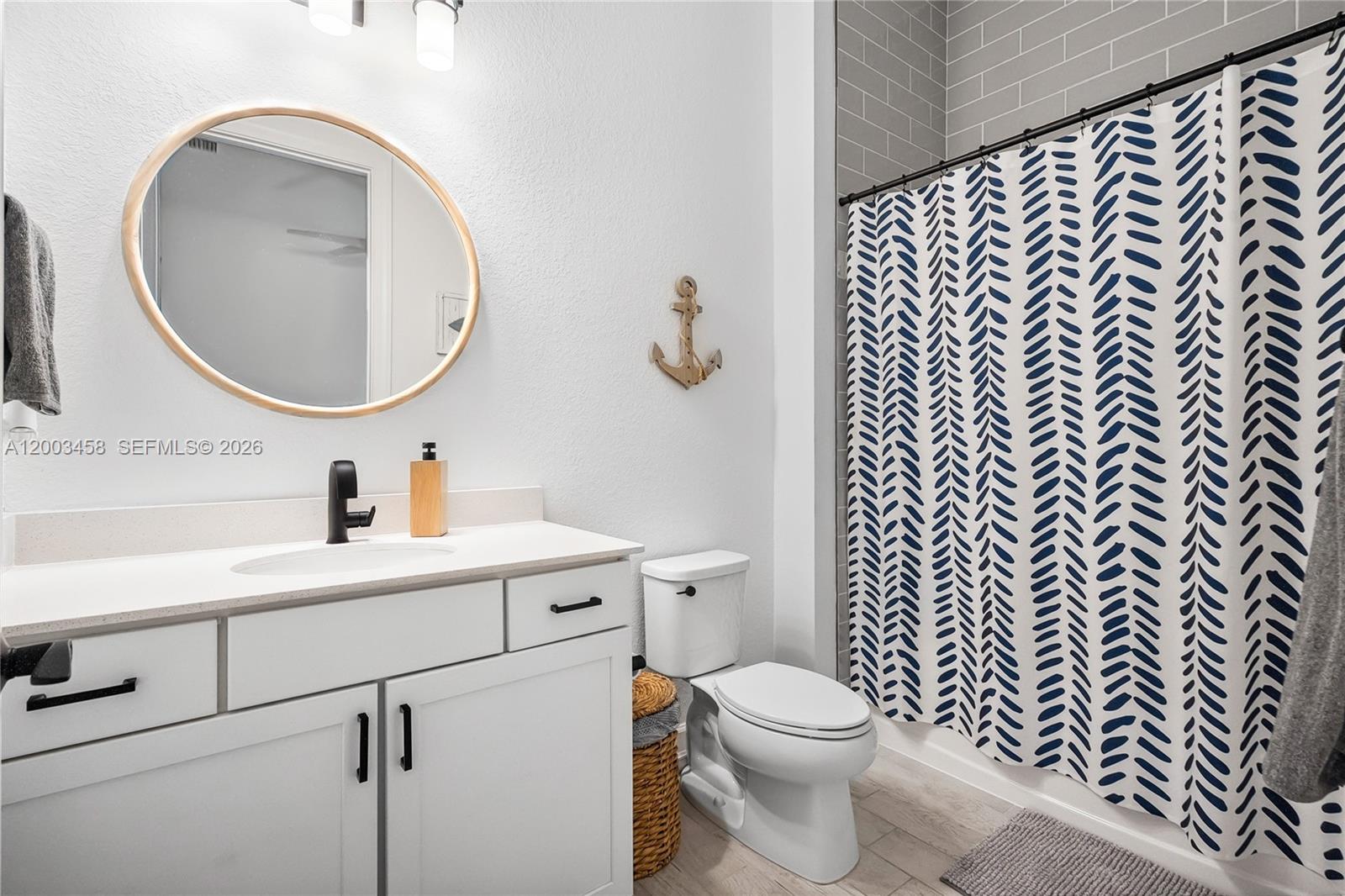 9734 Southwest Meridian Way Stuart, FL 34997 - Photo 30 of 48 a bathroom with a toilet a sink a mirror and vanity