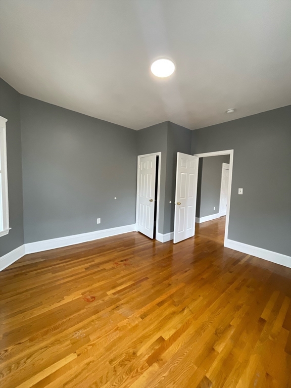 9 Page Street, Unit 2 Boston, MA 02121 - Photo 2 of 6 a view of an empty room with wooden floor