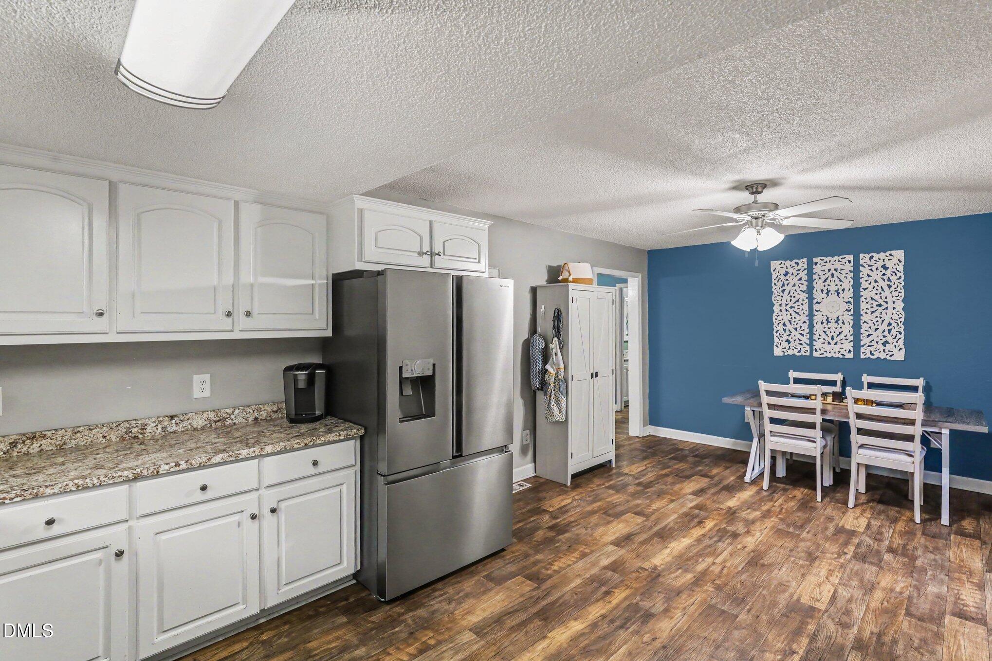 977 Stevens Mill Road Goldsboro, NC 27530 - Photo 14 of 31 a kitchen with refrigerator cabinets and a table