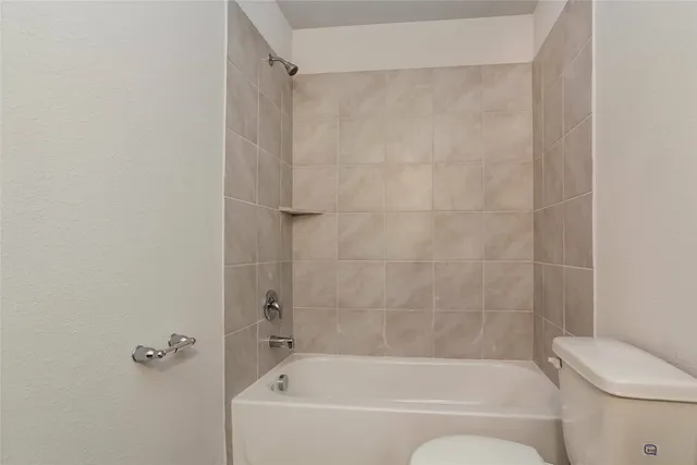 a bathroom with a bathtub and a toilet