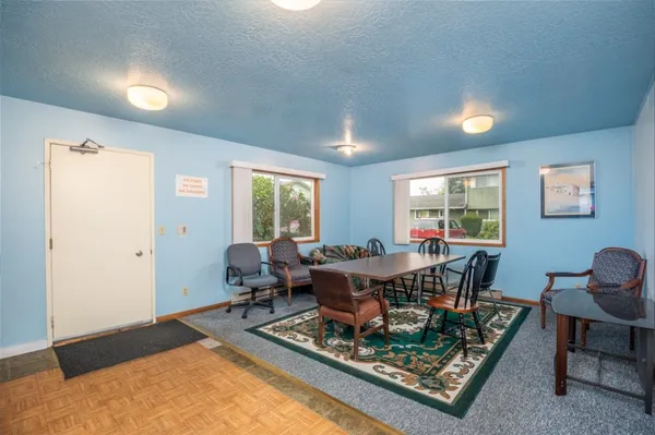a living room with furniture a rug and a window