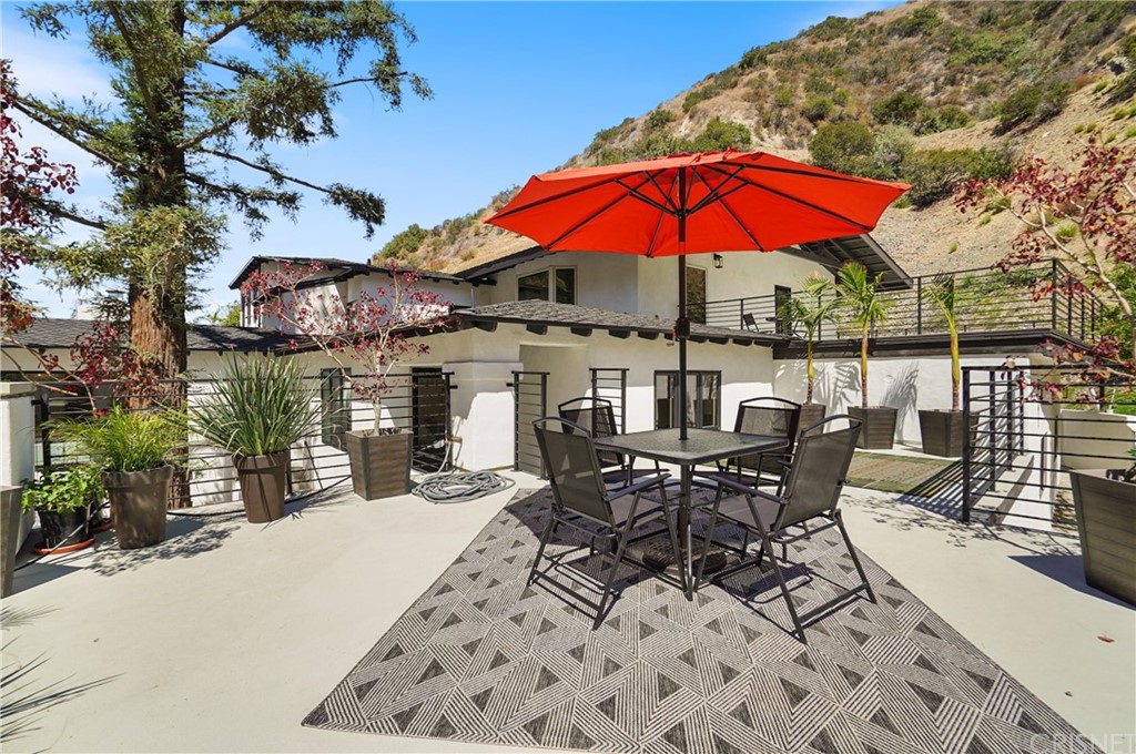 431 Nesmuth Road Glendale, CA 91202 - Photo 16 of 68 an outdoor space with furniture and umbrella